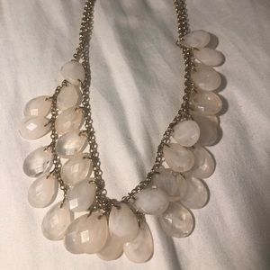 Gold colored chain with white and pink stones